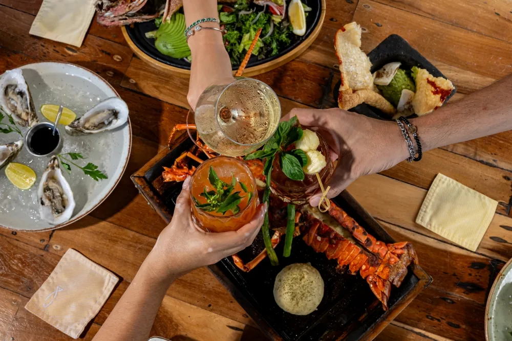 A toast over grilled lobster and oysters, seen from above