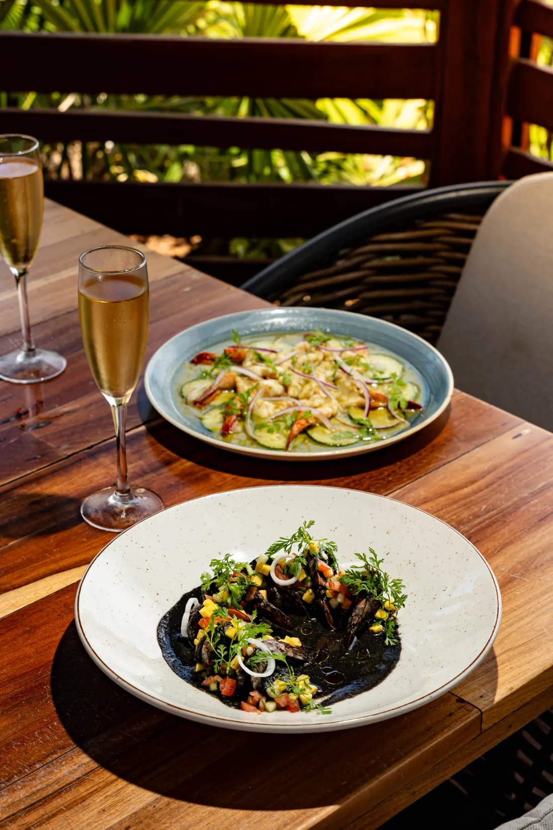 A set table with a glass of sparkling wine on the terrace